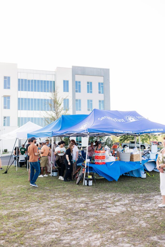 Security First team members under a tent entering to wind various raffled prizes 