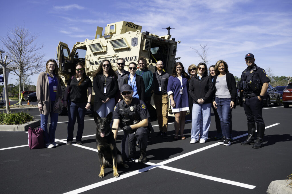 The Ormond Beach Police Department K-9 Unit and Security First Team Members in from of MCAT Vehicle at 2026 Storm Response Showcase