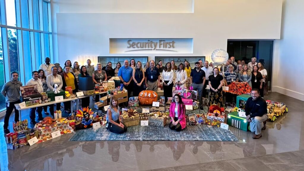 Group of team members posing at the headquarters for the Giving Thanks 2024 event.
