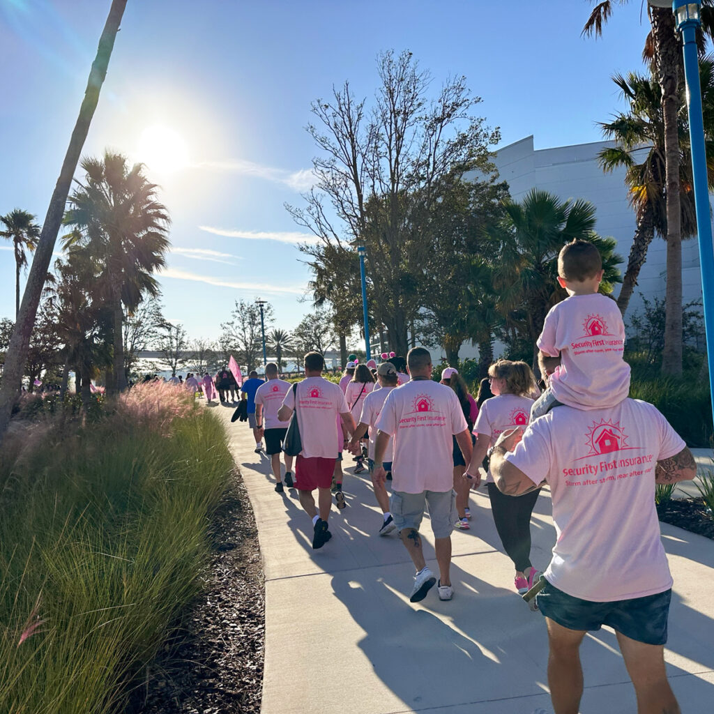 Team members walking as participants in the Making Strides Against Breast Cancer Walk.