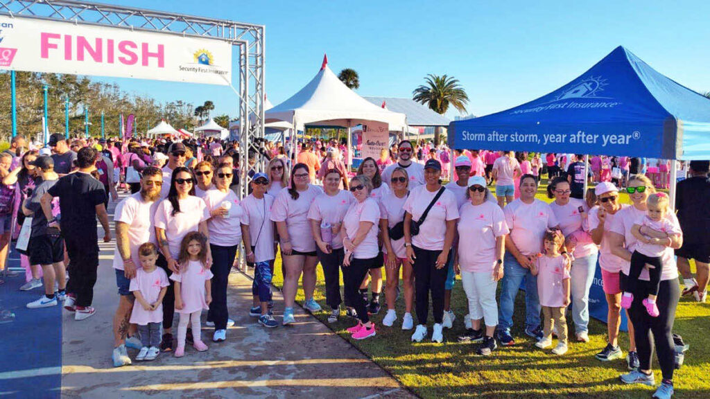 Group of team members pose at the finish line of the 2024 Making Strides Against Breast Cancer walk.